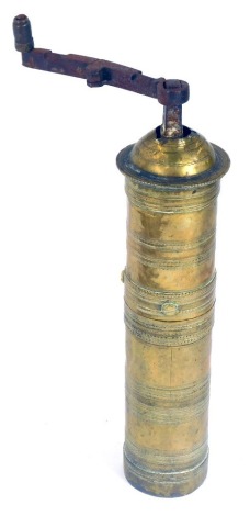 A Turkish brass coffee grinder, with turning handle and ribbed banding, 29cm high. (AF)