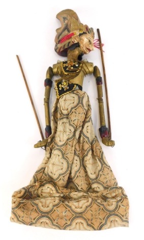 A Balinese carved wooden puppet, of a lady in flowing dress, with gilt material, 50cm high. (AF)