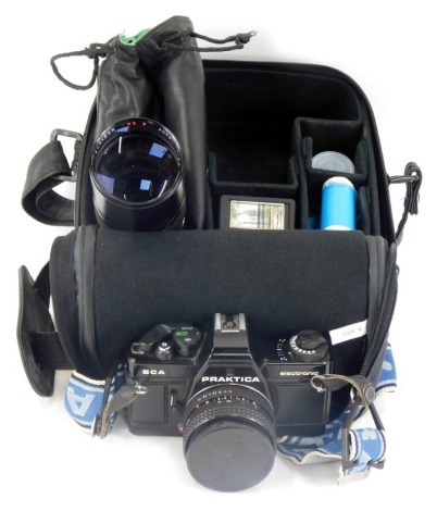 A Practica BCA electronic camera, with a Practica 1-18 lens, 1600A flash, and Sunagor 1-3.5 200mm lens, in material carry case.