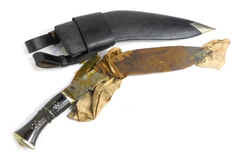 A Middle Eastern Kukri, with curved blade, on an ebony mother of pearl inlaid handle, with two miniature blades and a leather sheath, 38cm long.