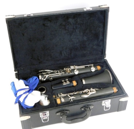 A cased clarinet, bearing barcoded label, stamped OITLO0CMO, in fitted black case, 12cm high, 37cm wide, 21cm deep.