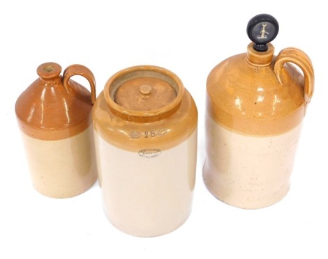 A collection of stoneware bottles, comprising a Woosa Oomer and Co, Pearson's of Chesterfield stoneware jar, 37cm high, a stoneware jar with paddle number two, 53cm high, and a Doulton Lambeth stoneware bottle, 37cm high. (3)