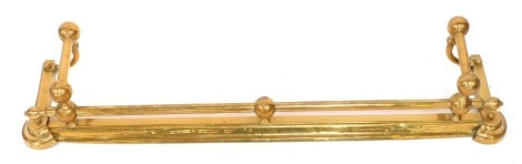 A Victorian brass fire fender, with scroll ends and adjustable front, 21cm high, 107cm wide, 21cm deep. (AF)