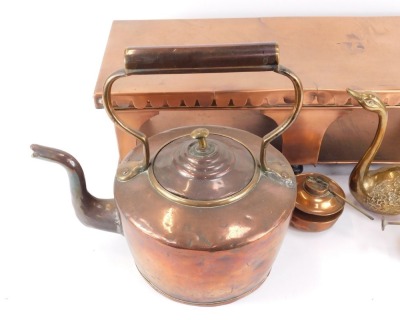 A 19thC copper plate warmer, with a fluted top, on rectangular base, with burners, 17cm high, 62cm wide, 24cm deep, a Victorian copper kettle, and two brass swans. (4) - 4