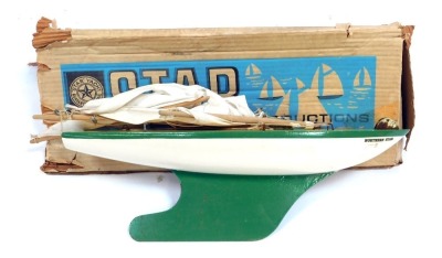 A Star Productions model pond yacht, with a cream hull with green and yellow design, 40cm wide, with mast, boxed.
