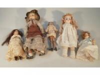 Four late 19thC bisque headed dolls and a naive wooden peg style doll