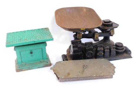 Vintage weighing measures, comprising a pair of cast iron table top scales, with arrangement of weights applied to base from 7lb downwards, 28cm high, 61cm wide, 25cm deep, a brass No 60T Salter scale, and a cast green metal weighted scale, 20cm high. (3)