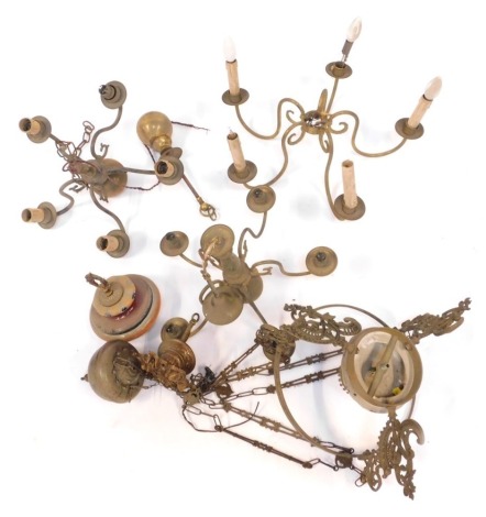 A group of light fittings, comprising three five branch brass chandeliers, a pottery hanging oil lamp, etc. (a quantity)