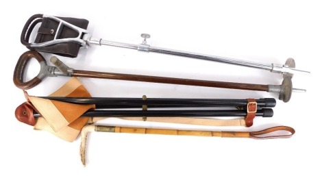 A Howells of London shooting stick, another, and a tripod shooting seat. (3)