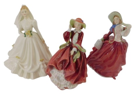 Three Royal Doulton figures, comprising Autumn Breezes HN1934, Top O' The Hill HN1824, and Bride (Ivory) HN3285, each 20cm high. (3)