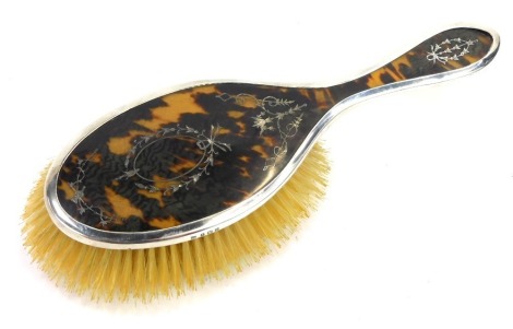 A George V silver dressing table brush, with tortoise shell and pique flower scroll inset design, Birmingham 1923, 25cm high.