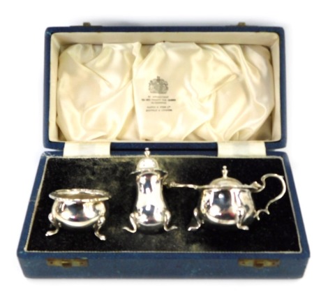 A George V silver three piece cruet set, comprising pepper, salt and preserve jar, with single spoon bearing figural head, Mappin & Webb, Sheffield 1931, in presentation case, By Appointment To Her Majesty The Queen Silversmiths, 4.78oz gross.