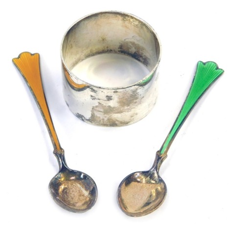 A George VI silver napkin ring, of plain design, Birmingham 1937, and two Norwegian enamel and silver coffee spoons, one green one orange, stamped 925, 0.67oz gross. (3)