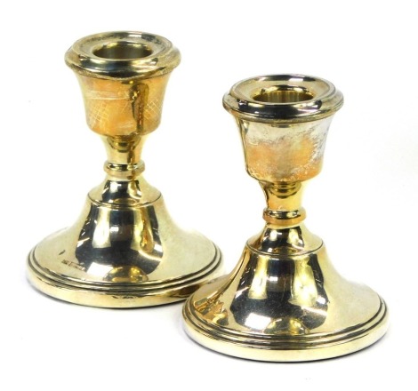 A pair of George V silver dwarf candlesticks, with weighted bases, Birmingham 1919, 11.4oz. (2)