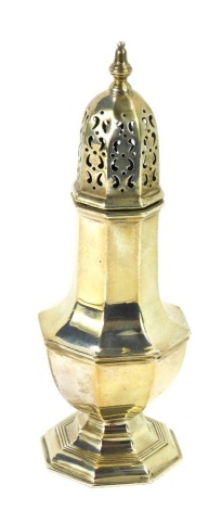 A George V silver sugar sifter, of octagonal baluster form, with a pierced moulded top, serial no 75168, London 1935, 6.08oz, 20cm high.