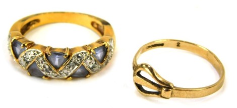 Two dress rings, comprising a 9ct gold buckle ring, 1.6g, and a modern dress ring, of half hoop design, set with purple and white stones on cross border, on a yellow coloured band, size P½. (2)