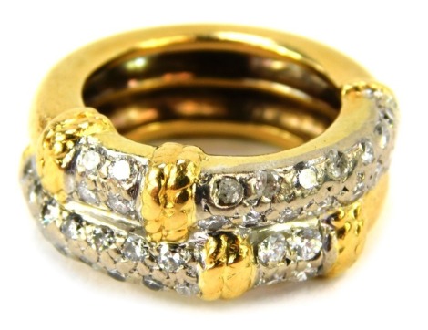 An 18ct gold and diamond dress ring, formed as two rings, in bicolour decoration, set with round brilliant cut diamonds, in illusion setting, approx 1.5ct overall, size L, 13.1g all in.