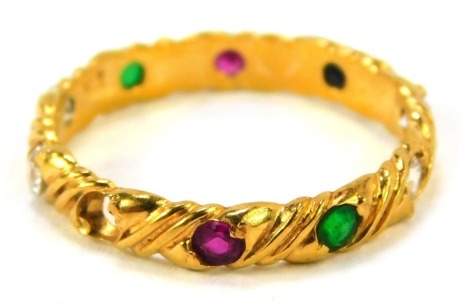 A stone set wedding band, set with rubies, diamonds, emeralds and sapphires, in twist design setting, size N½, yellow metal stamped 22ct, 2.9g all in. (AF, 1 stone missing)