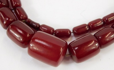 A cherry amber beaded necklace, with oblong faceted graduated beads, the largest 2.5cm wide, the smallest 1cm wide, on a knotted string strand, 88.3g all in. - 2