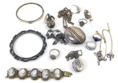 A group of silver and other jewellery, to include a Victorian silver locket, with applied and engraved detail, 5cm x 3.5cm, on curb link chain, 52cm long, a small group of silver dress rings, unmarked neck chains, mirror finish cameo bracelet, bangles, et