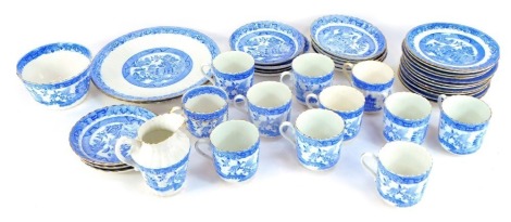 A late 19thC English porcelain blue and white tea service, in the Real Old Willow pattern, comprising cake plate, milk jug, sugar bowl, eleven teacups, eleven saucers, eleven side plates.