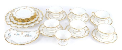 A Royal Crown Derby Vine pattern porcelain part tea service, comprising six teacups and saucers, sugar bowl, shaped cake plate, five side plates, two medium plates, and one large plate.