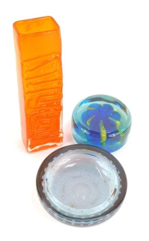 Three items of Art Glass, comprising a Whitefriars tangerine Totem vase, 25cm high, a Mdina turquoise and yellow glass paperweight, etched mark, 11cm diameter, and a Whitefriars bubble ashtray, 15.5cm diameter. (3)