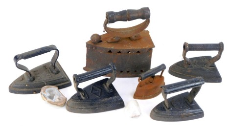 A Victorian box iron and four flat irons, and two geodes. (7)