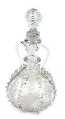 A 19thC twin handled cut glass decanter and stopper, possibly Dutch or German, of globe and shaft from, etched with birds and vines, interspersed with vertical ribbing, 27cm high.