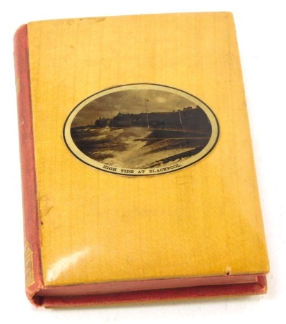 A Mauchline ware bound miniature book, Chips from Dickens, selected by Thomas Mason, published by David Bryce and Son, the front cover reserved with a photograph of High Tide at Blackpool 9cm high.