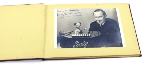 An autograph book, containing a black and white photograph of Harry Corbett and Sooty, with ink dedication, together with other autographs.