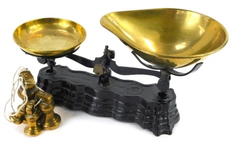 A set of vintage Salter scales, on a black metal base, with brass weights, 16cm high, 32cm diameter.