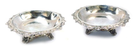 A pair of Ottoman bon-bon dishes, each with a shell capped and berry border rim, on three scroll feet, white metal stamped 900 and ATZHTIPH, 15cm diameter, 13.86oz.