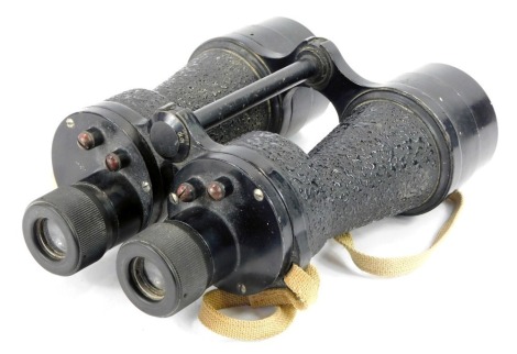 A pair of World War II military field binoculars, with a 60-70 degree angle adjustment, in black metal casing, with a tan coloured strap, 21cm high.