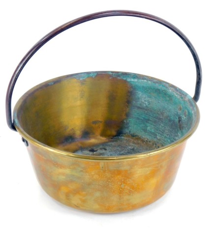 A brass jam pan, with a copper handle, 34cm wide.