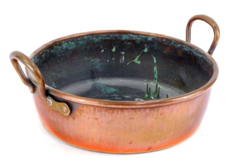 A copper wide bottomed twin handled jam pan, 44cm wide.