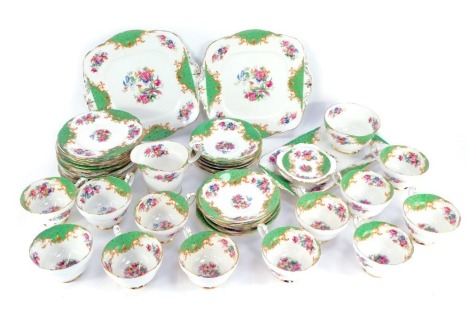 A Paragon Rockingham pattern porcelain tea service, comprising pair of bread plates, cream jug, sugar bowl, sandwich plate, pair of spoon dishes, twelve cups, fourteen saucers and tea plates. (1 tray)