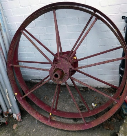 A pair of cast iron cartwheels, each painted in red and inscribed Highfield of Newark, and numbered 9821, 112cm diameter.