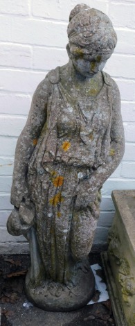 A reconstituted stone figure of a Roman female, in flowing robes with water vessel, on circular base, 100cm high.