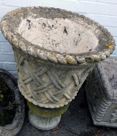 A 19thC reconstituted stone planter, the planter with cross hatched design, on a small circular base, 65cm high.