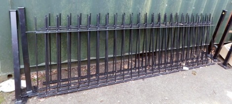 Four black metal garden gates, and five posts, the posts 91cm high, the gates 84cm high, 275cm wide.