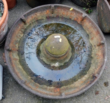 A cast iron metal Mexican hat feeding trough, 70cm diameter.