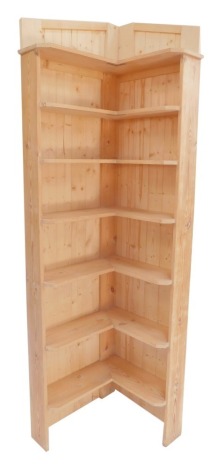 A pine corner bookshelf, with arrangement of six shelves, 192cm high, 56cm deep.