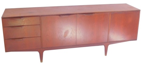 An A H McIntosh and Company Limited teak sideboard, with three graduated drawers to the left, pair of central doors opening to reveal a shaped shelf, and a drop down drinks cabinet to the right, raised on turned legs, 74cm high, 201cm wide, 46.5cm deep.