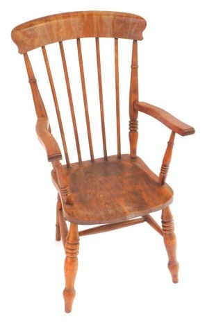 A Victorian oak and elm lath back kitchen chair, with solid saddle seat, raised on turned legs united by an H framed stretcher, 57cm wide.