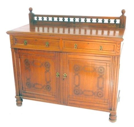 A Victorian oak sideboard, with a galleried back over two drawers, above a pair of carved panelled doors opening to reveal four sliding shelves and a drawer, raised on turned legs, 115cm high, 127cm wide, 56cm.