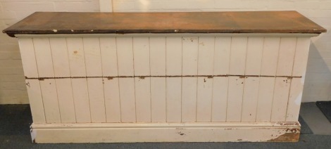 A Victorian stained and white painted shop counter, with a panelled front, raised on a plinth base, 94cm high, 221cm wide, 58.5cm deep.