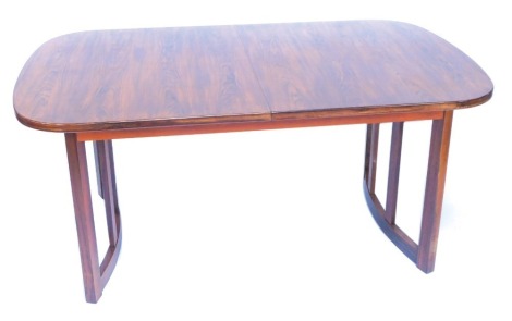 A late 20thC rosewood draw leaf dining table, possibly Danish, with curved square supports, 73cm high, 160cm wide, 210cm extended, 100cm deep.