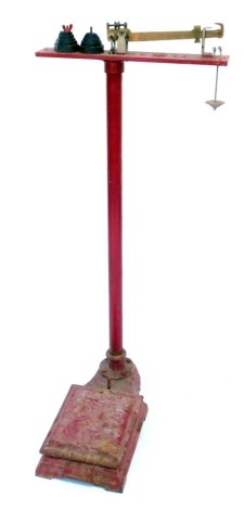 A set of W and T Avery Limited red painted cast iron balance scales, with weights, 134cm high.