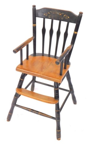 A Victorian ebonised oak and beech child's high chair, with crest rail decorated with a bowl of fruit and flowers, curved seat and foot rest, raised on turned legs united by a box stretcher, 36cm wide.